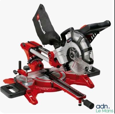 a close up of a red and black circular saw on a white background