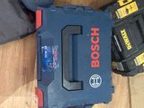 a man kneeling on the floor with a tool box