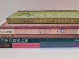 five books stacked on top of each other on a table