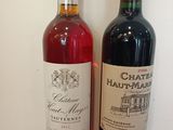 two bottles of wine sitting next to each other on a table