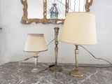 two lamps sitting on a table with a mirror in the background