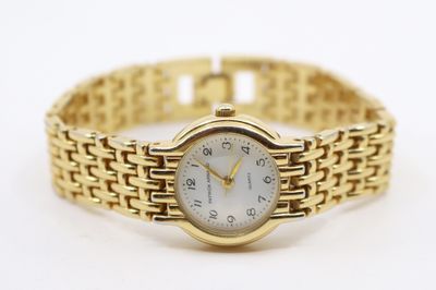 une image d'un gros plan d'une montre-bracelet sur une surface blanche