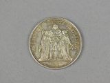 an image of a silver coin on a white surface