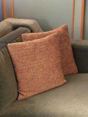 a couch with a pillow on it in a living room