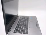 a laptop that is open on a white surface