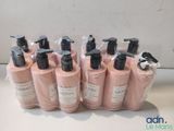 six bottles of body lotion sitting on top of a counter