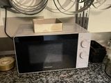 a microwave that is sitting on a counter in a kitchen