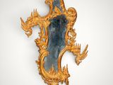 an image of a mirror with a gold frame on a white wall