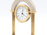 a clock that is sitting on a marble table
