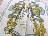 a white and gold scarf with a picture of a horse and carriage