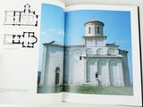 an open book with a picture of a church in it