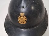 an old fireman ' s helmet with a badge on it