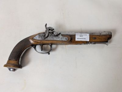 a close up of a gun on a white surface with a tag on it