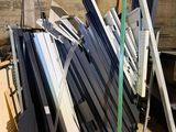 many different types of windows on a pallet in a warehouse