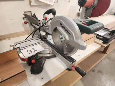 une photo d'une scie circulaire posée sur un établi dans un atelier