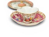 two tea cups and saucers on a white table