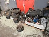 a pile of old tires and wheels in a garage