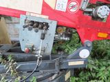 a red tractor that is parked in the grass