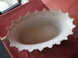 a white bowl sitting on top of a red table