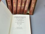 a book open on a table next to a box of books