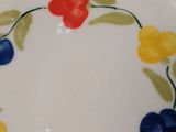 a plate with a flower design on it on a table