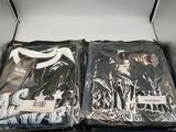 an open box with two shirts in it on a table