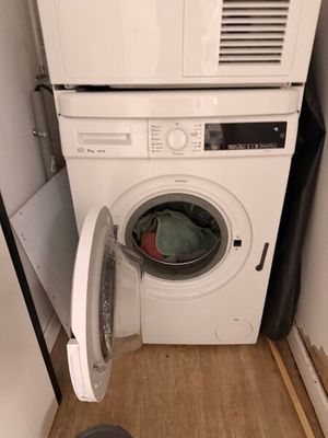 an image of a washer and dryer in a small room