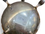 a silver plate with a tag on it on a white surface