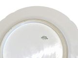 a white plate with a gold rim on a white background