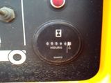 a close up of a button on the side of a yellow vehicle