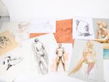 a lot of drawings on a table with a chair