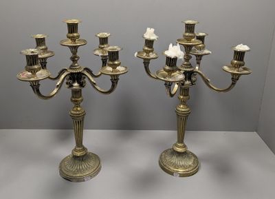 une paire de chandeliers anciens en laiton, ornés de fleurs blanches et de bougies