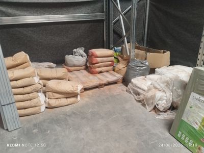 several bags of food are sitting on a table in a warehouse