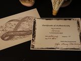 a picture of a certificate on a table next to a vase of flowers