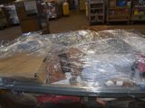 a baby in a stroller wrapped in plastic in a store