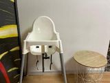 a baby high chair in the corner of a room