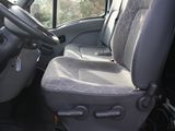 a seat in the back of a van with a seat cover on