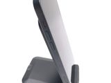 a cell phone that is on a stand on a white surface