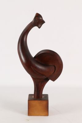 an image of a wooden sculpture of a bird on a wooden base