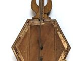 an old wooden musical instrument hanging on the wall