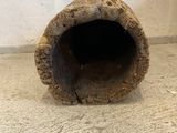 a piece of wood sitting on the floor next to a wall