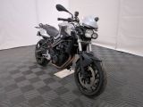 a motorcycle that is parked on a black and white checkered floor