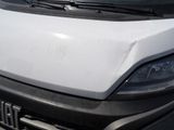 a white van that has been vandalized and is parked in a parking lot