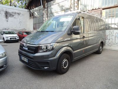 a silver van parked in a parking lot next to other cars