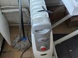 an image of a room with a heater and a mop on the floor