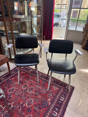 two chairs in a room with a rug on the floor
