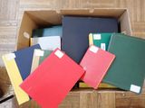 many folders in a box on the floor
