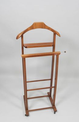a wooden coat rack with a coat hanger on it