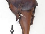an old leather holster with a key in it on a white surface