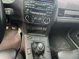 a dashboard of a car with a steering wheel and a control panel